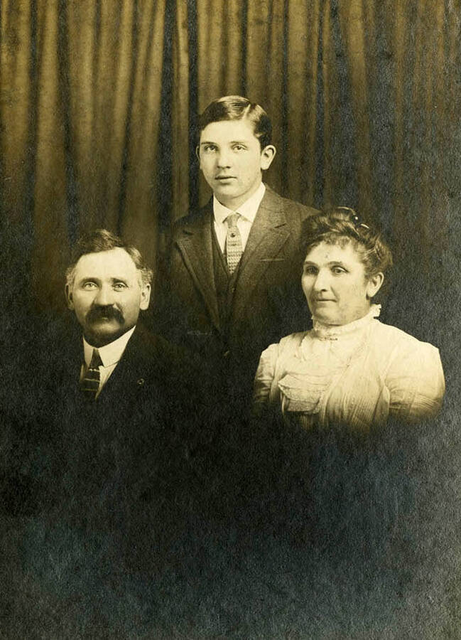 The Nirk family portrait. Names read as subjects appear, left to right, front to back: Nirk, John Matthew; Allen, Bertha Clemina; Nirk, Durell Irwin.