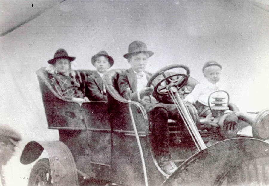 Frances, Frank, Fred, and Curt in automobile.