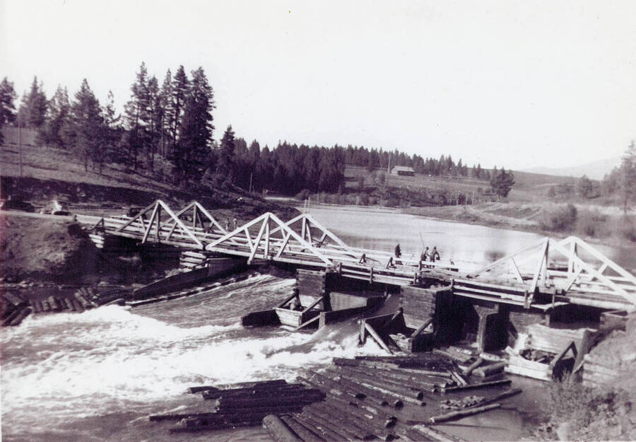 Rock Creek bridge and dam across the Palouse River at Potlatch. American Legion Cabin on hill in the background.