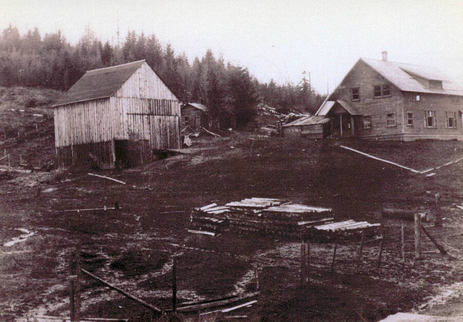 The old Kellmer place. Stacks of logs can be seen piled up outside the buildings.
