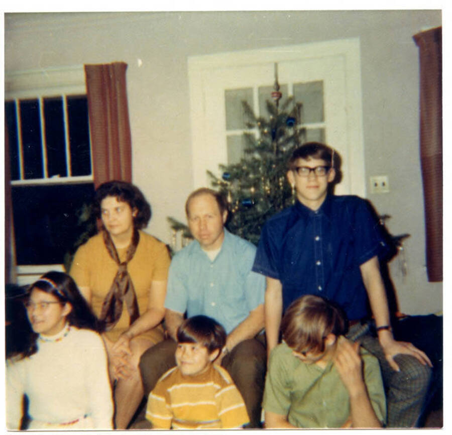A photograph of the Fleener family. Names read as subjects appear, left to right, front to back: Fleener, Juanita Kay; Fleener, Phillip; Fleener, Timothy Paul; Fleener, Marva Joyce; Fleener, Loyal Ivan; Fleener, Craig Loyal.