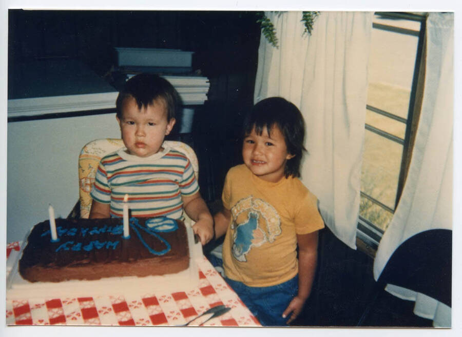Dustin Fleener sits in front of his birthday cake, while Shannen Fleener stands beside him for Dustin's 2nd birthday.