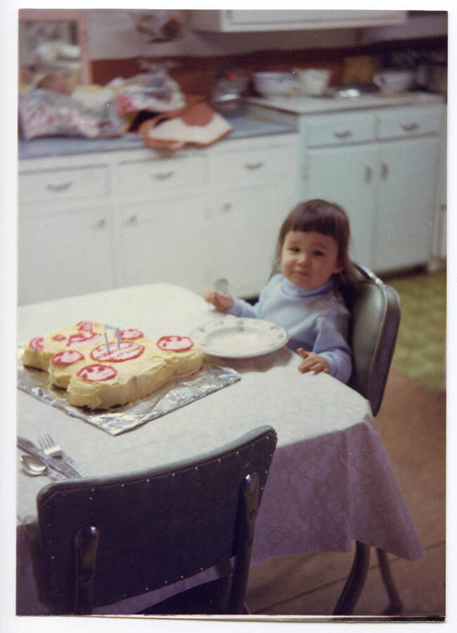 Shannen Fleener sits in front of her teddy bear birthday cake for her 2nd birthday.