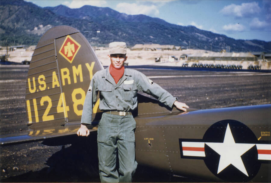 Norman Soncarty standing by Army plane 11248