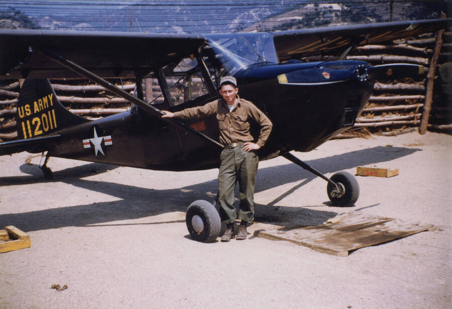 Norman Soncarty leaning on single-engine plane