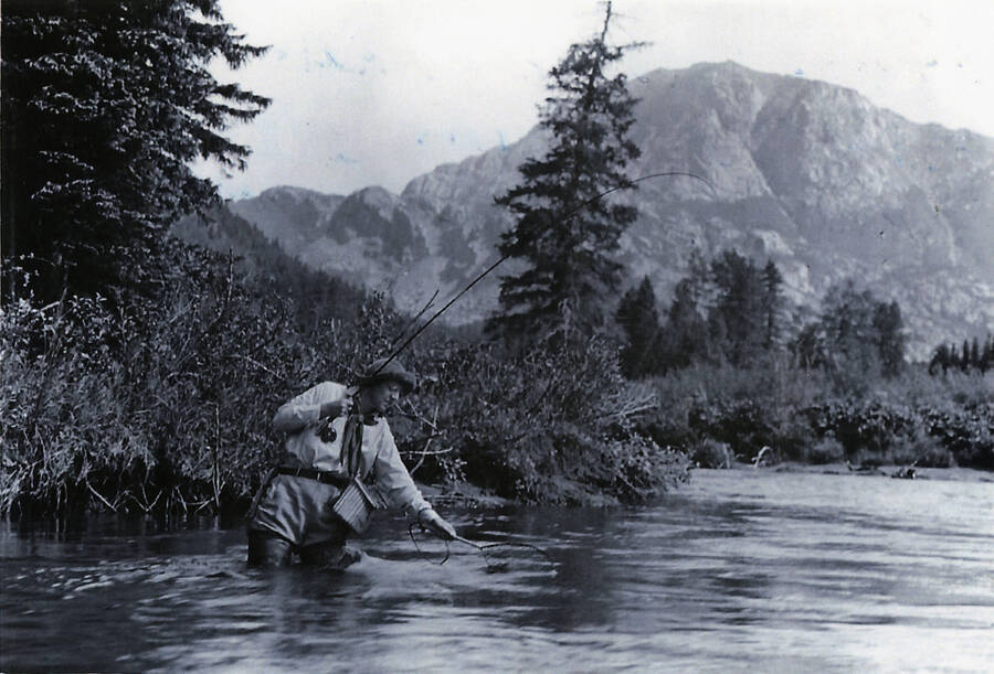 Rose (wife of Charles) fishing for trout in Spruce Tree camp at Granite Peaks, Colorado