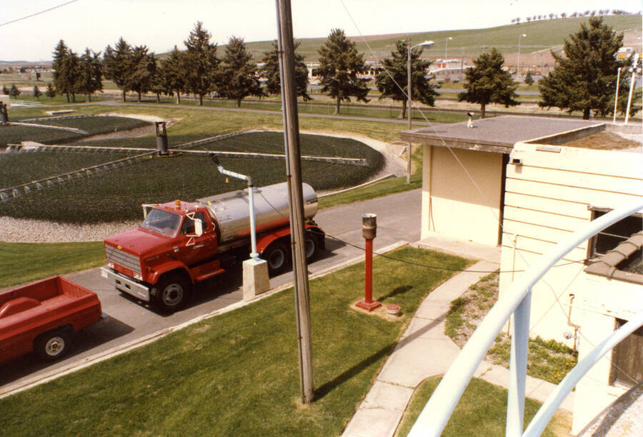 Old plant with new sludge delivery truck. Used to spread liquid sludge on U of I farm grounds (1985)