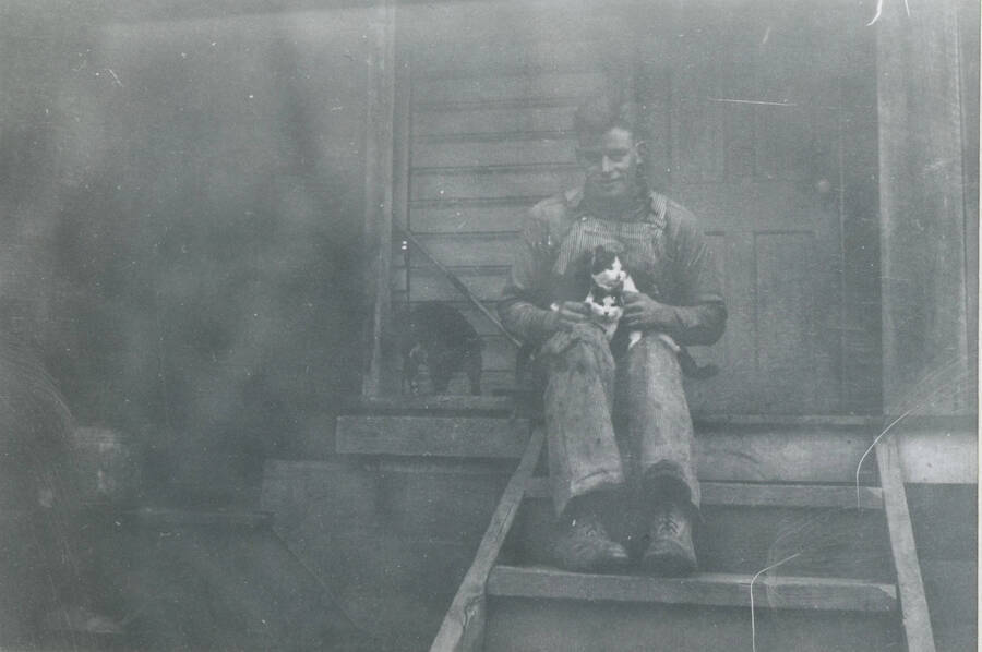 Dwight Strong (and cat) on back steps of our first old house by the highway.