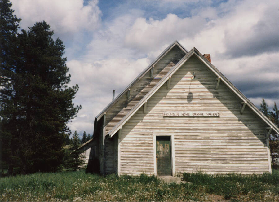 Photo of Mountain Home Grange in 1987. Dwight Strong helped log the timber for the lumber and helped build the first part of the building.