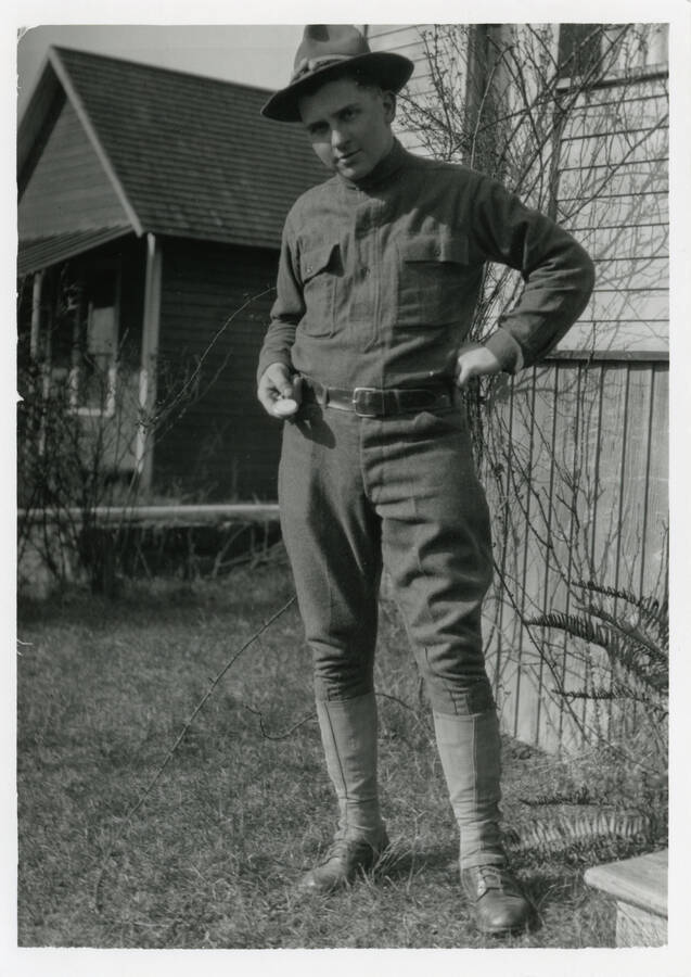 Photo of Durell Nirk in WWI US Army Uniform in front of houses