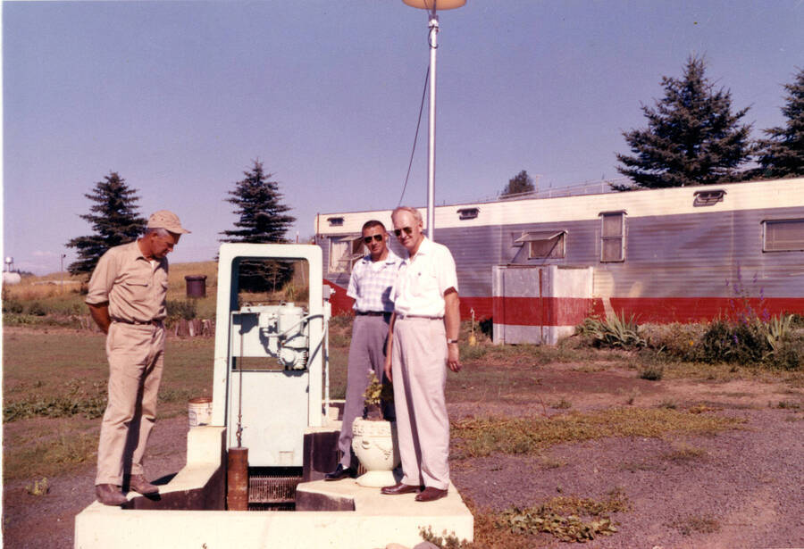 Operator Lyle Brouse and two unknown city employees admiring new Influent Barmanutor Bar Screen (pre 1970)
