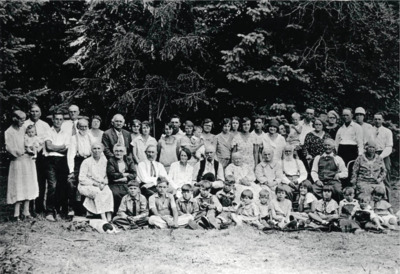 Picture taken on Charley Byseggers place when all the families were home to visit one summer. Left to right back row: Mrs. Halenbeck holding grandson John Jr. Bysegger, John Bysegger, Curtis Katzenberger, Charles Bysegger, Rose Bysegger, John Nirk, Emma (Bysegger) Davis, Clara (Bysegger) Brandt, Cleora Nirk, Durell Nirk, Ida Soncarty holding baby son Norman, Mary Nirk, Elsie Kazenberger, ?, Louise Katzenberger, Russell Strong, Lois Bysegger, Beth Adams holdin gson Babbie, Ernie Arrasmith, Mamie Beuchamp, Lois Arrasmith, Arthur Strong, Alice Strong, Edward Bysegger. Middle Row seated: Lettie Strong, Bertha Nirk, J. V. Katzenberger, Myra Katzenberger, Ralph Strong, Jane Strong, Anna Bysegger, Fred Bysegger, Rudolph Zimmerman and Lizzie Zimmerman. Seated on ground front row: Gerald Nirk, Eugene Bysegger, Glen Nirk, Lwell Soncarty, Dwight Strong, Velma, Dean, Elezabeth, Isla Bysegger, Leala Nirk, Max Davis, Lyle Strong, Norma Jean Nirk.