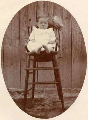 Portrait as a baby in a high chair.