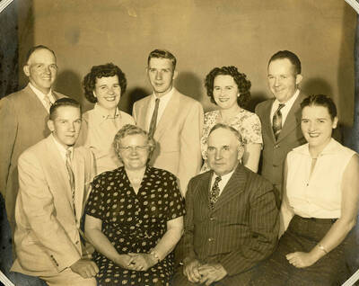 Nirk Family portrait. Names read as subjects appear, left to right, front to back: Nirk, Larry; Nirk, Mary Anna Bysegger; Nirk, Durrell; Nirk, Irwin; Nirk, Norma Jean; Nirk, Gerold; Nirk, Leola; Nirk, Ronald; Nirk, Cleora; Nirk, Glen.