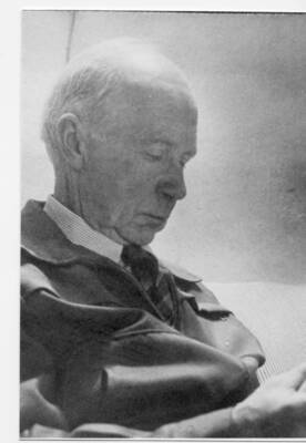 Ansel Fleener sits reading in a chair.