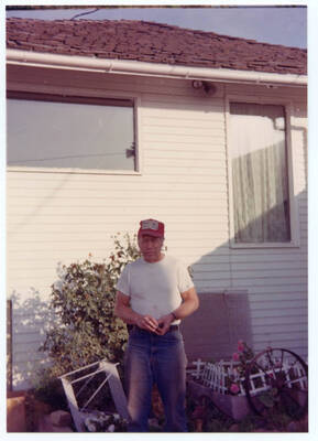 Loyal Fleener stands for a photograph in front of the Fleener home.