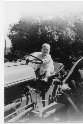Craig Fleener sitting on top of a Ford NAA Tractor. Loyal Fleener acquired the tractor from his parents.