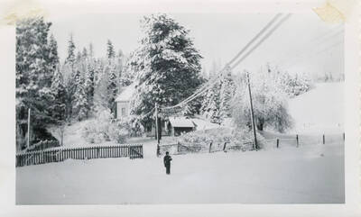 Allen Strong in front of the Katzenberger house where we lived before building our new house on the highway. Winter.