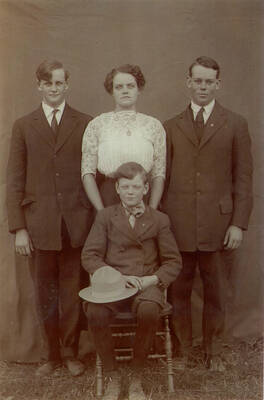 Photo of the Strong Family: (left to right) Ralph, Jane, Addie, Lois, Arthur, Roswell (seated), Irving (on Roswell's lap)