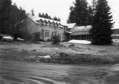 Bovill's Hotel surrounded by trees and with a little snow on the ground.