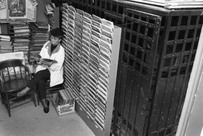 Karen Eggers reading a magazine at the Bovill Library, which was in the back of City Hall where the old jail cells were.