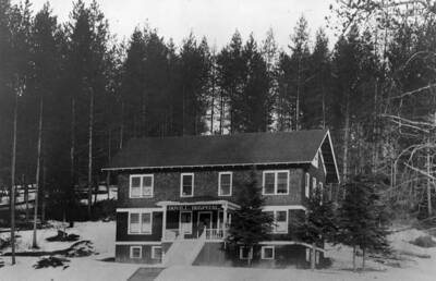 Bovill Hospital surrounded by trees and snow.