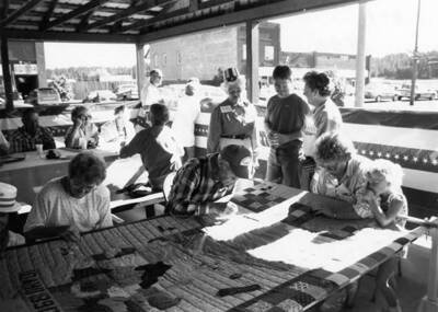 Bovill residents working on the centennial quilt during Bovill's Statehood Day celebration.