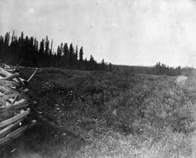 View of the Bovill meadow with a split rail fence in the left corner and Abe's Butte in the distance.