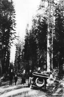 Bovill residents stand near a car on the side of the road between Bovill and Hog Meadow. From (l to r) Okia Hall, unknown, Mrs. R. C. Witty, Mrs. Hall, Lee Witty.