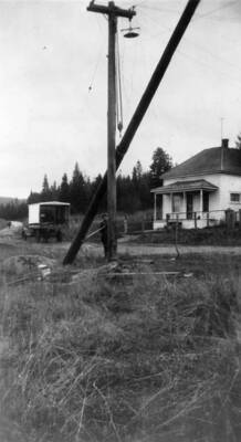 Bovill's new power pole being raised by a Ford truck.