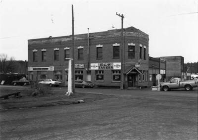 Bovill's first state bank, with cars parked on the street outside.
