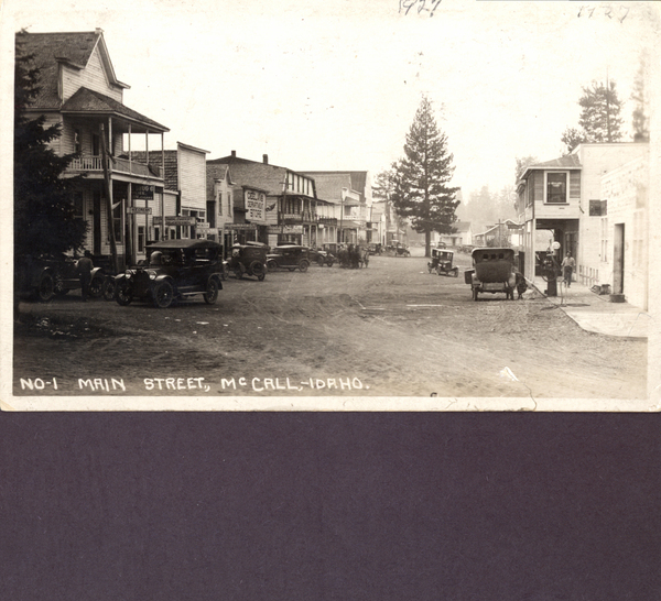 Main Street McCall with a view of old buildings and cars on both sides of the street. Image contains the text: "NO. 1 MAIN STREET, McCALL, IDAHO."