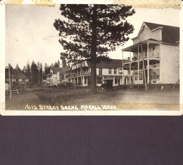 NO 13 Street Scene McCall, Idaho, view of a hotel, along with other large buildings, and cars parked in front of buildings, Property of Dan De Francesco. Image contains the text: "1013 STREET SCENE MCCALL IDAHO"