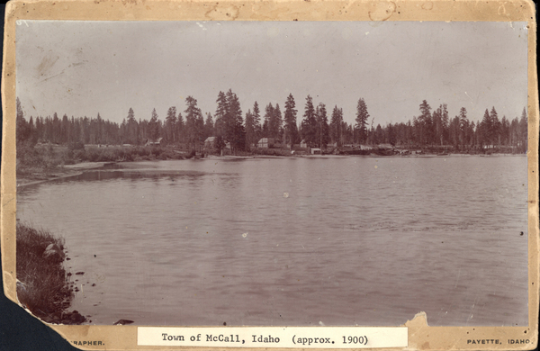 Town of McCall approx. 1900, with a view of the lake and in the background there are the buildings of McCall. Image contains the text: "Town of McCall, Idaho approx 1900"