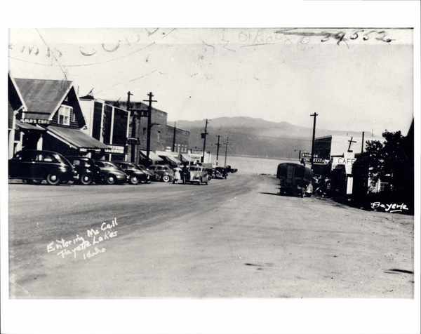 McCall Business block with a view of entering McCall Payette Lakes Idaho, also in view are some buildings like Lola’s cafe and the Texaco Station. Image contains the text: "Entering McCall Payette Lakes Idaho"