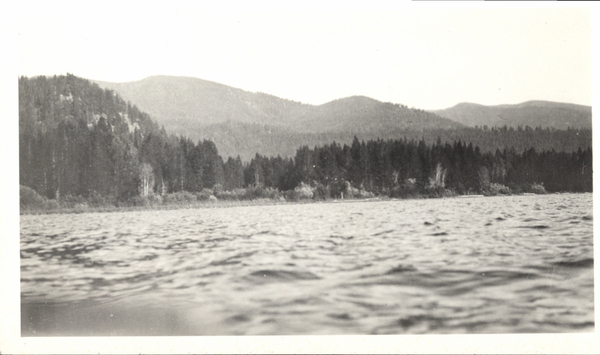 View of Payette Lake in the foreground in the back pine trees and mountains