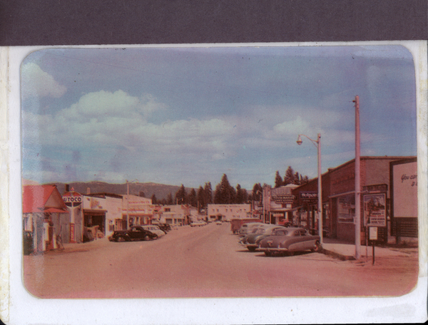 E. Lake street there are cars parked on both sides of the road, buildings are in view like Conoco, Hotel McCall, Lola’s Cafe, and more