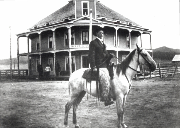 Hotel Roseberry with a man on horseback in front of building. Image contains the text: "HOTEL ROSE"