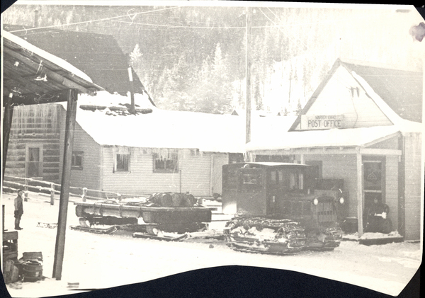 Warren- post office with tractor pulling mailsled. Image contains the text: "WARREN IDAHO   POST OFFICE"