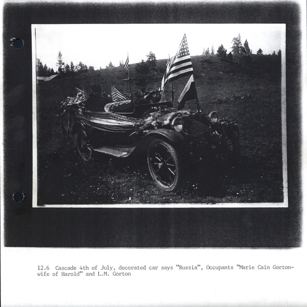 Photocopy of the 4th of July, a decorated car says “Russia,” occupants “Marie Cain Gorton- wife of Harold “ “L.M. Gorton”. Image contains the text: "12.6 Cascade 4th of July decorated car says Russia Occupants Marie Cain Gorton wife of Harold and L.M. Gorton"