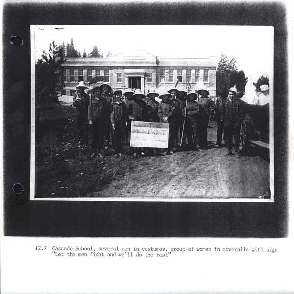 Photocopy of the 4th of July, school, several men in costumes, group of women in coveralls with sign “Let the men fight ans we’ll do the rest”. Image contains the text: "12.7 Cascade School several men in costumes group of women in coveralls with sign Let the men fight and we'll do the rest"