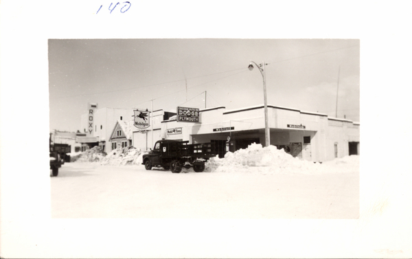 Cascade Auto and Roxy Theater. Image contains the text: "140  ROXY  Mobilgas  Mobil Tires  CASCADE AUTO INC DODGE PLYMOUTH  MOBILIOIL  MOBILUBRICATION"