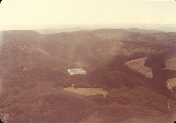 Original colored aerial photograph of mountain and a flowing river