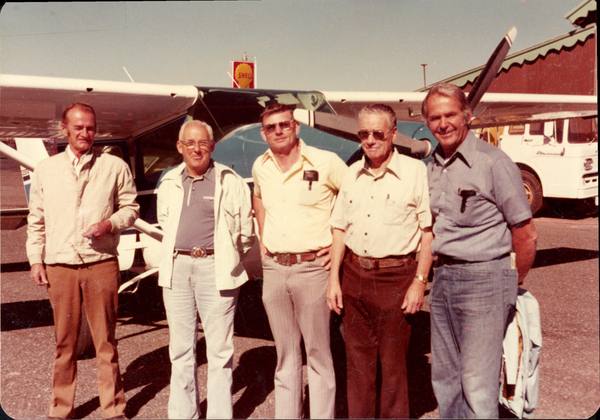 Original colored photograph of five men with Cessna, identity unknown. Image contains the text: "Shell"