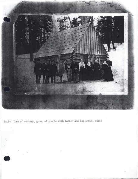 Photocopy of “Turn of century, group of people with batten and log cabin, skies. Image contains the text: "14.14 Turn of century group of people with batten and log cabin skiis"