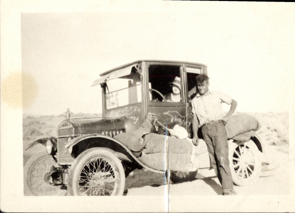 Man and women with a early car, “George Teeter-moving to McCall”