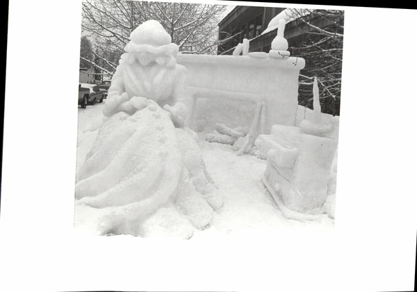 Ice sculpture of Cinderella with a mantel, fireplace, and a dresser