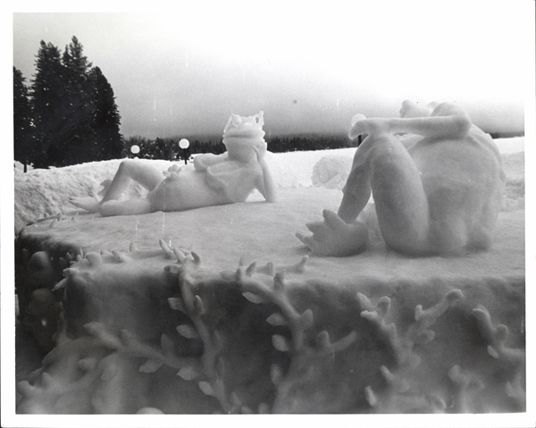 An ice sculpture of frogs lounging