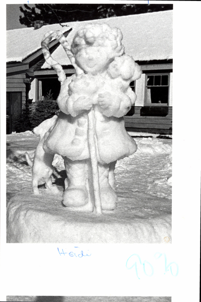 A ice sculpture of Heidi in front of a building. Image contains the text: "Heidi 90%"