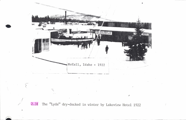 Photocopy of “Lyda” cruise boat on land in the winter in front of Lakeview Hotel. Image contains the text: "McCall Idaho - 1922  2.31 The "Lyda" dry-docked in winter by Lakeview Hotel 1922"